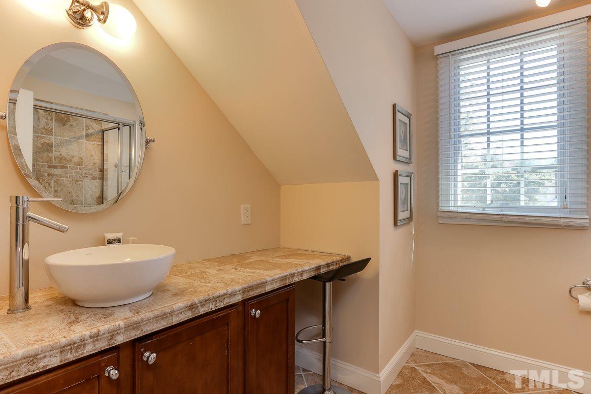1705 Pony Run Road Raleigh, NC 27615 - Photo 18 of 22 a bathroom with a granite countertop sink and a mirror