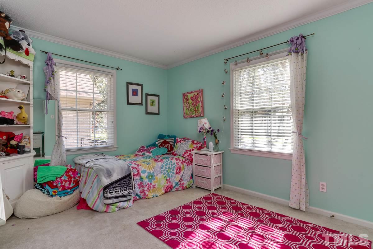 1705 Pony Run Road Raleigh, NC 27615 - Photo 19 of 22 a bedroom with a bed and a window