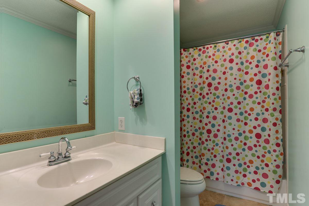 1705 Pony Run Road Raleigh, NC 27615 - Photo 20 of 22 a bathroom with a sink toilet and shower