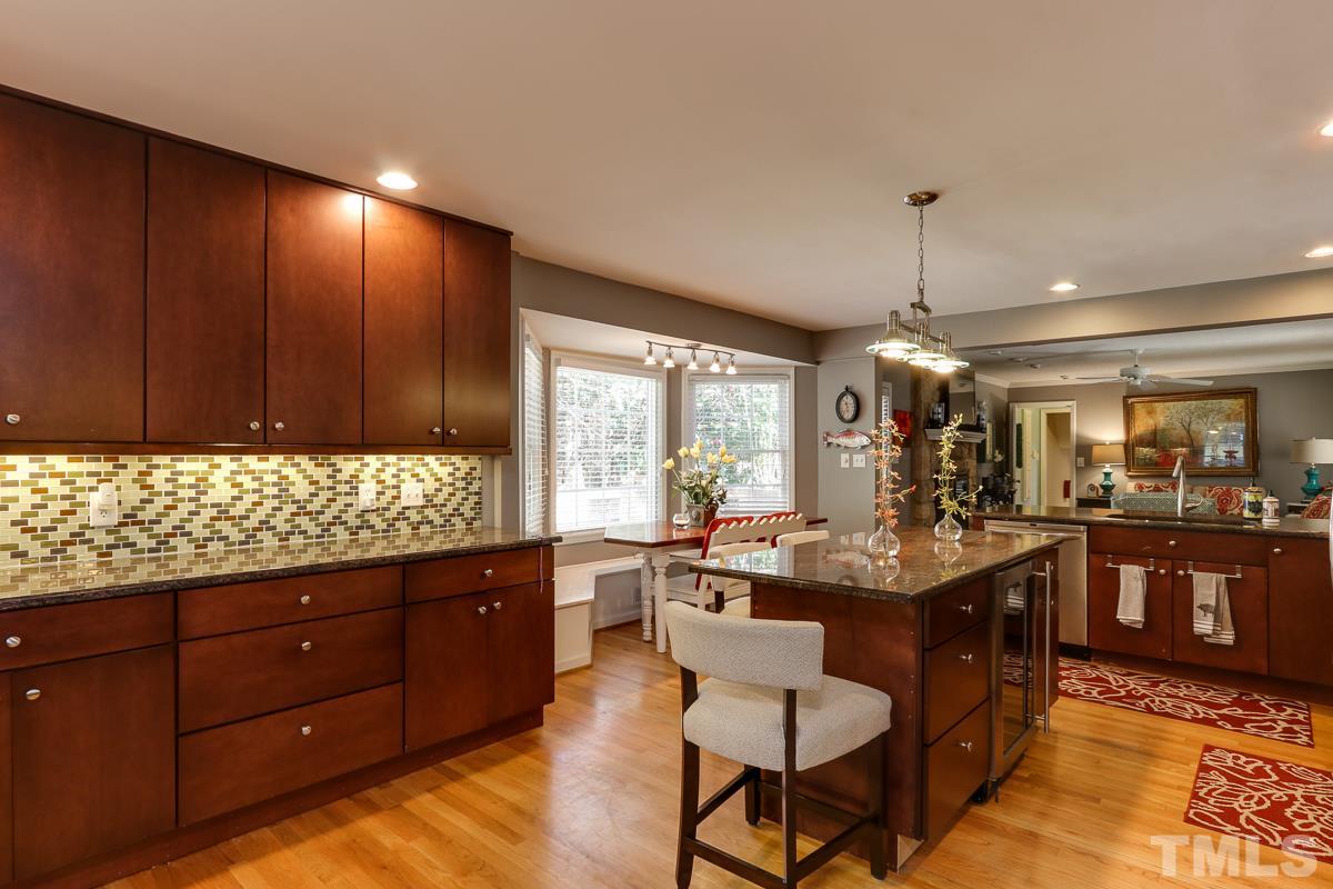 1705 Pony Run Road Raleigh, NC 27615 - Photo 4 of 22 a kitchen with granite countertop wooden cabinets and stainless steel appliances