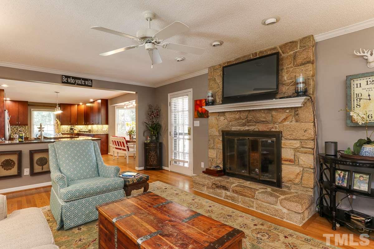 1705 Pony Run Road Raleigh, NC 27615 - Photo 8 of 22 a living room with furniture a flat screen tv and a fireplace
