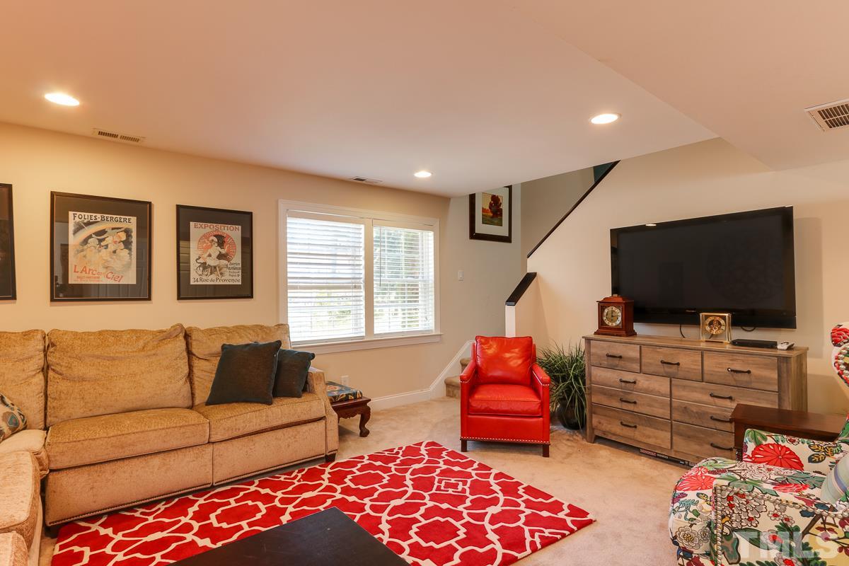1705 Pony Run Road Raleigh, NC 27615 - Photo 9 of 22 a living room with furniture and a flat screen tv