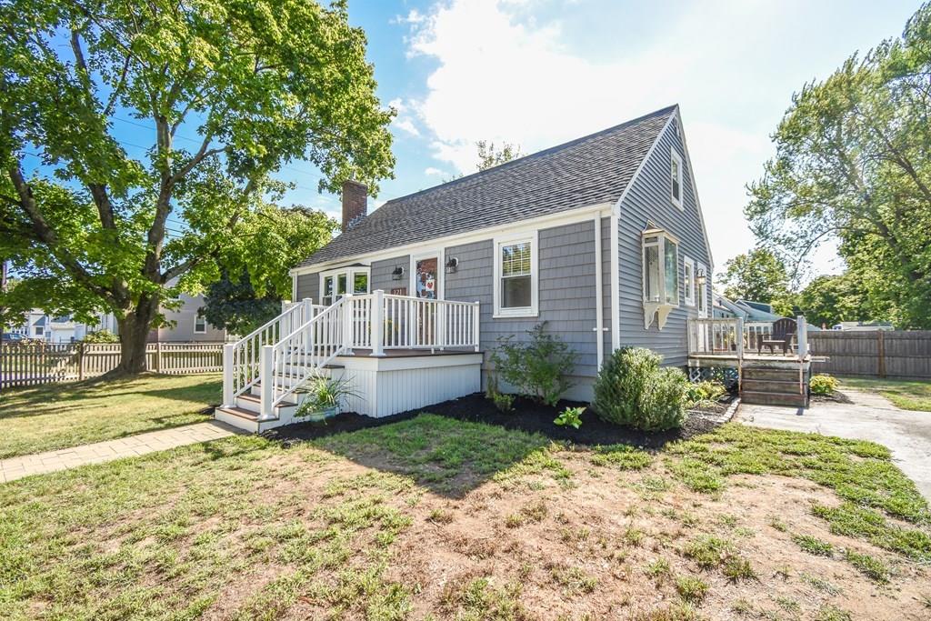 a view of a house with backyard and sitting area