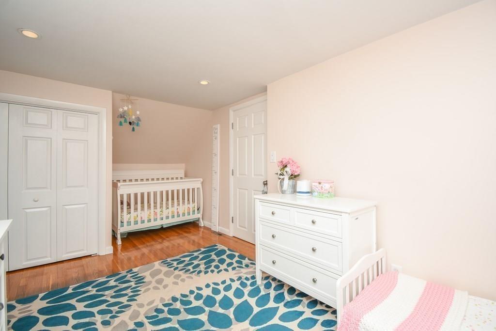 121 Moreland Road Weymouth, MA 02191 - Photo 19 of 40 a room with a baby crib and dresser