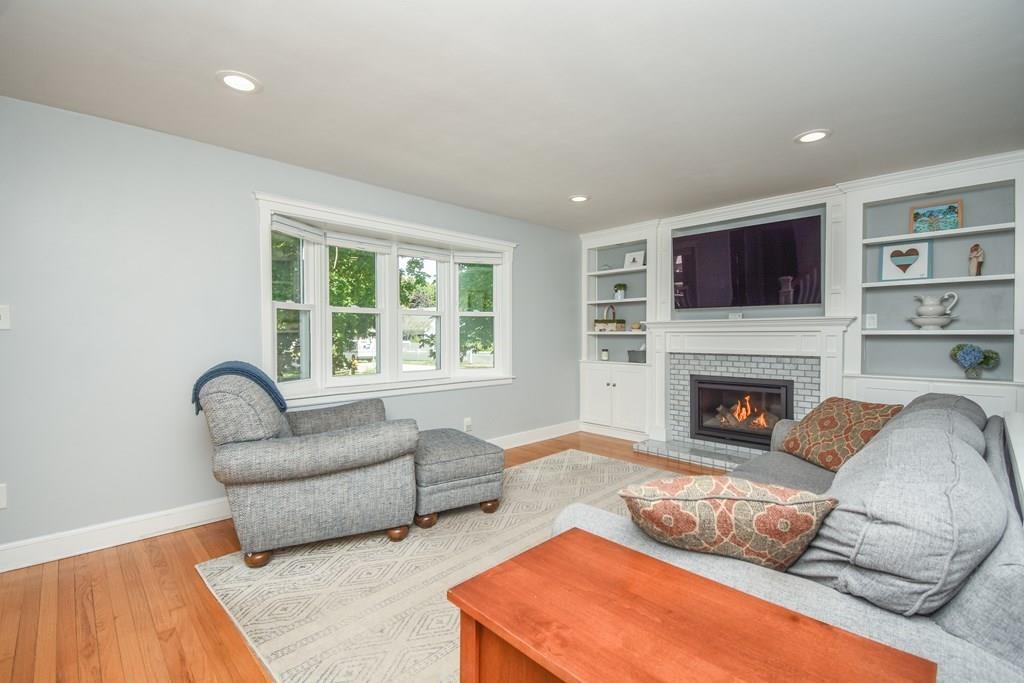121 Moreland Road Weymouth, MA 02191 - Photo 4 of 40 a living room with furniture a flat screen tv and a fireplace