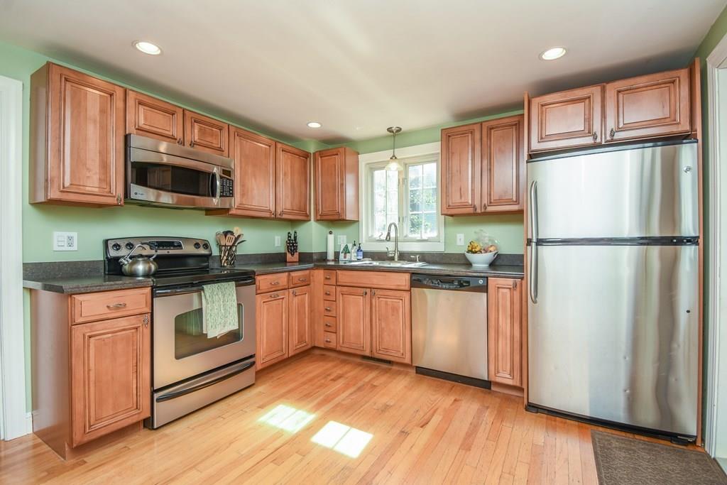 121 Moreland Road Weymouth, MA 02191 - Photo 6 of 40 a kitchen with granite countertop stainless steel appliances a refrigerator cabinets and a window
