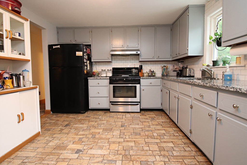 61 Central Street Saugus, MA 01906 - Photo 12 of 42 a kitchen with a refrigerator and cabinets