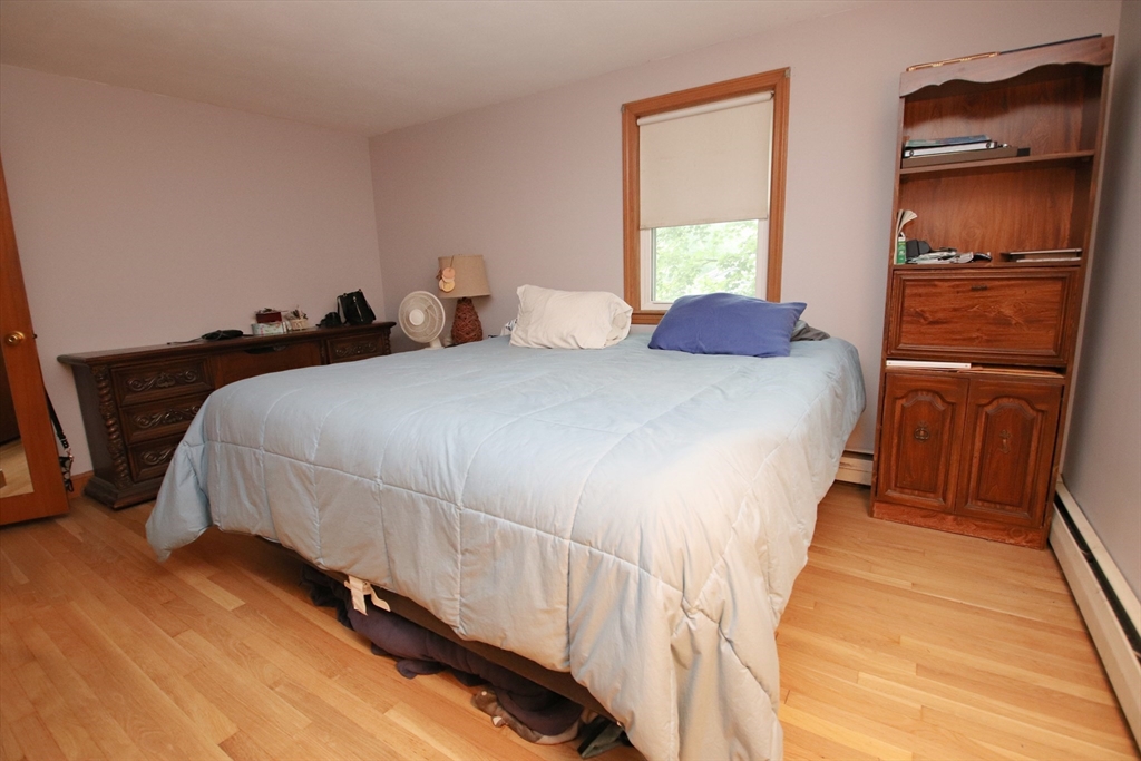61 Central Street Saugus, MA 01906 - Photo 13 of 42 a bedroom with a bed and wooden floor