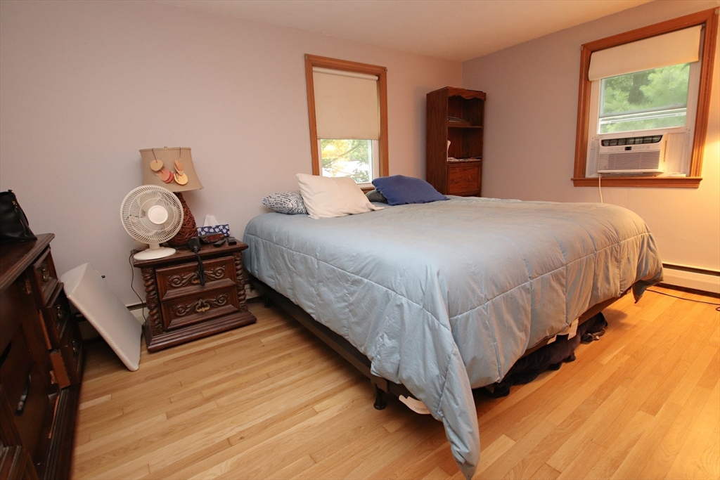 61 Central Street Saugus, MA 01906 - Photo 14 of 42 a bedroom with a bed and a dresser next to a window
