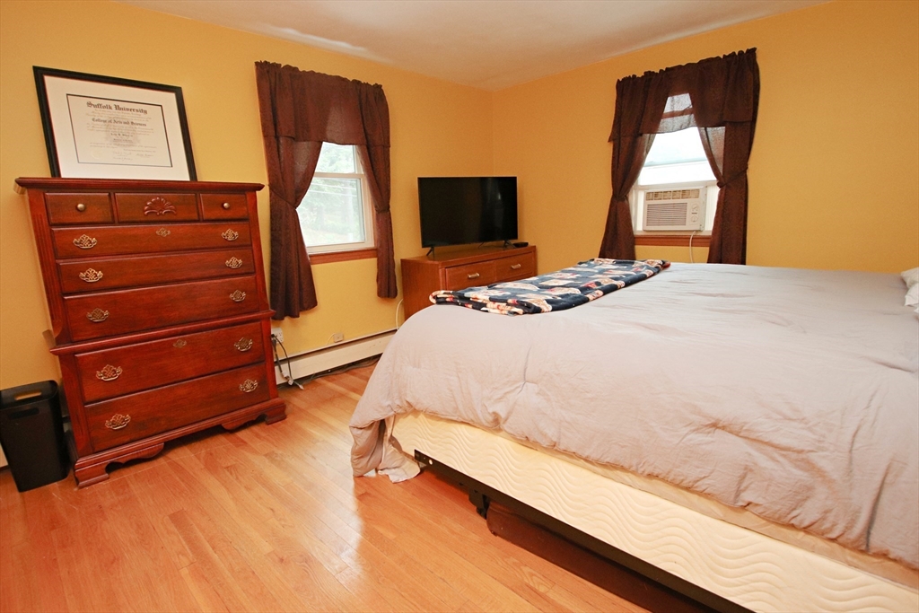 61 Central Street Saugus, MA 01906 - Photo 17 of 42 a bedroom with a bed and a flat screen tv