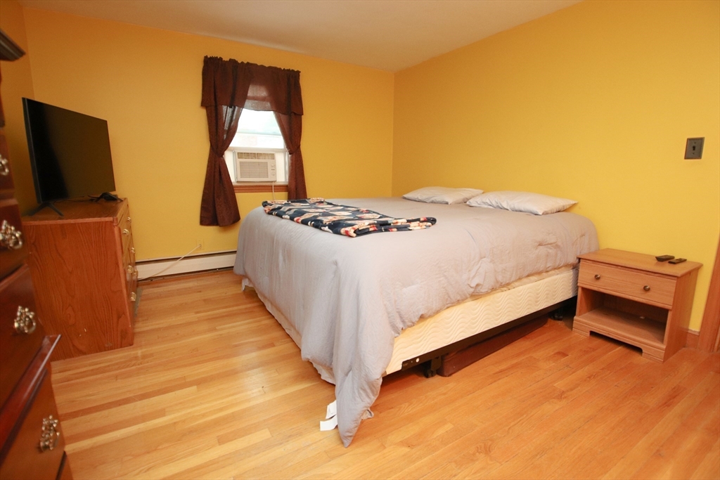 61 Central Street Saugus, MA 01906 - Photo 18 of 42 a bedroom with a bed and flat screen tv