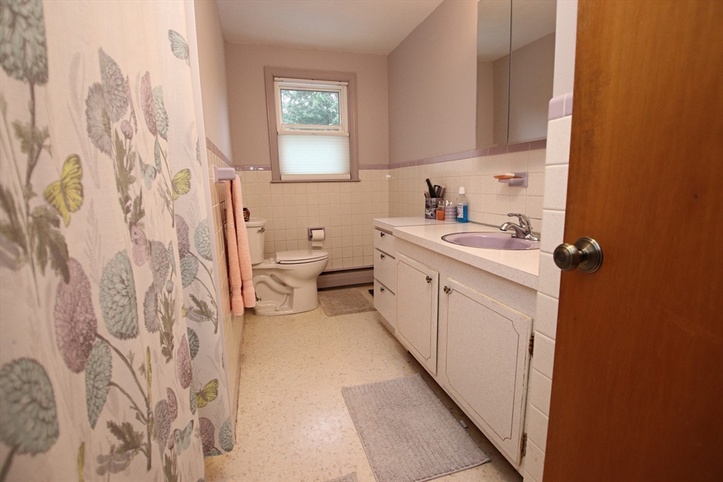 61 Central Street Saugus, MA 01906 - Photo 21 of 42 a view of a bathroom with a sink and a mirror