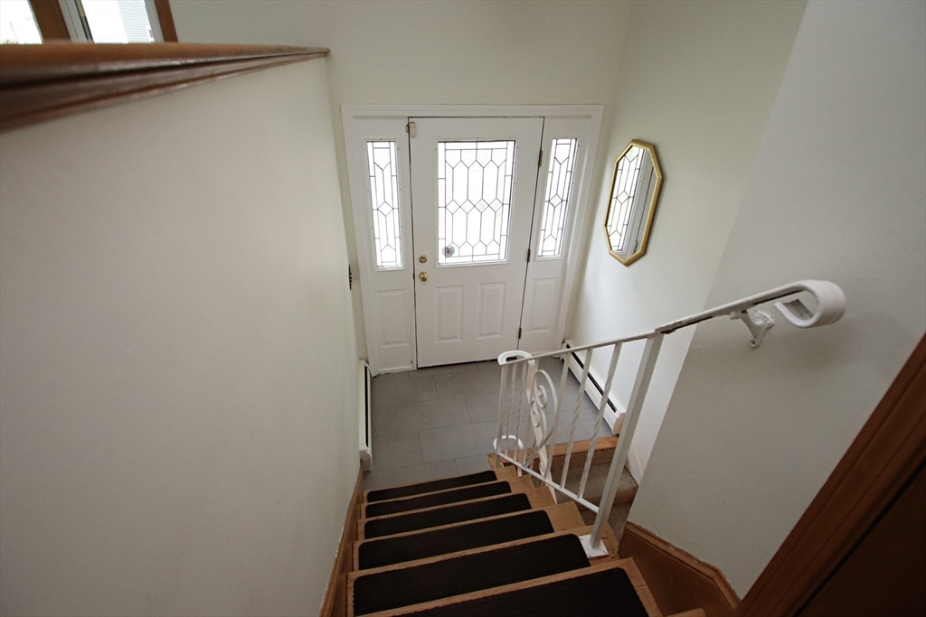 61 Central Street Saugus, MA 01906 - Photo 24 of 42 a view of staircase with wooden floor and white walls