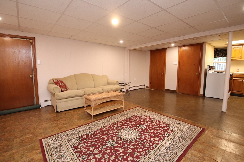 61 Central Street Saugus, MA 01906 - Photo 28 of 42 a living room with a couch and a rug