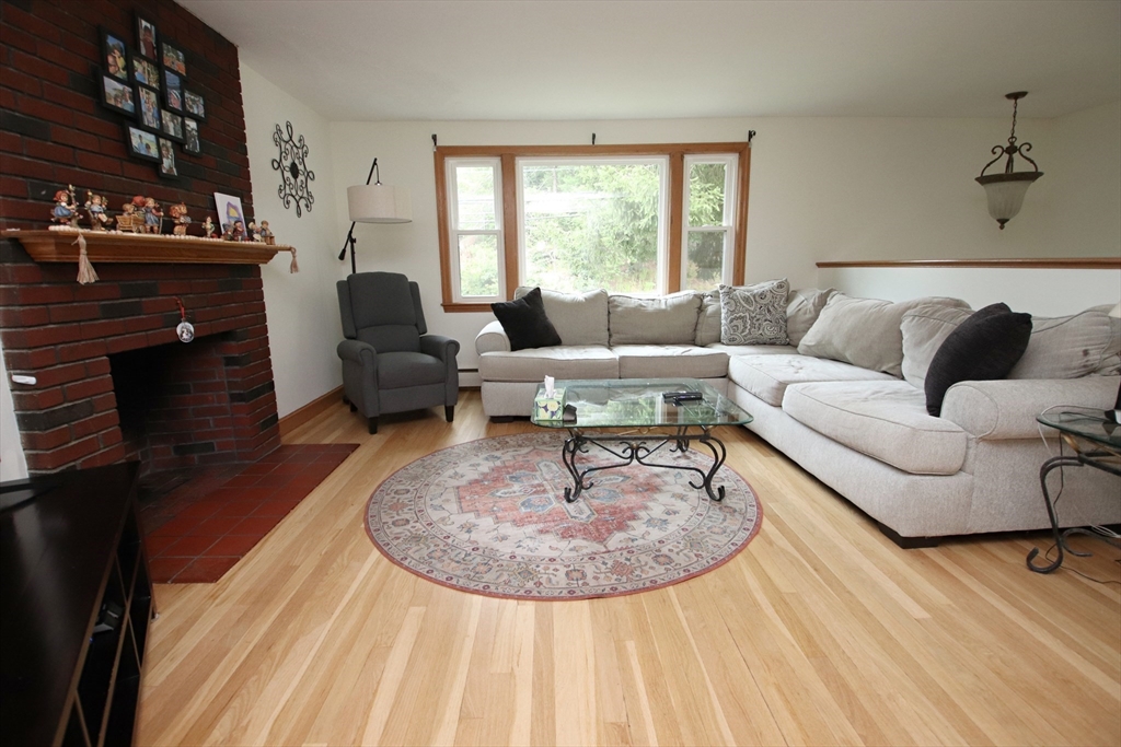 61 Central Street Saugus, MA 01906 - Photo 4 of 42 a living room with furniture and a fireplace
