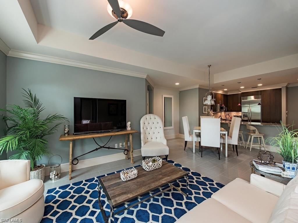 9123 Strada Place, Unit 7306 Naples, FL 34108 - Photo 7 of 19 a living room with furniture a rug and a flat screen tv