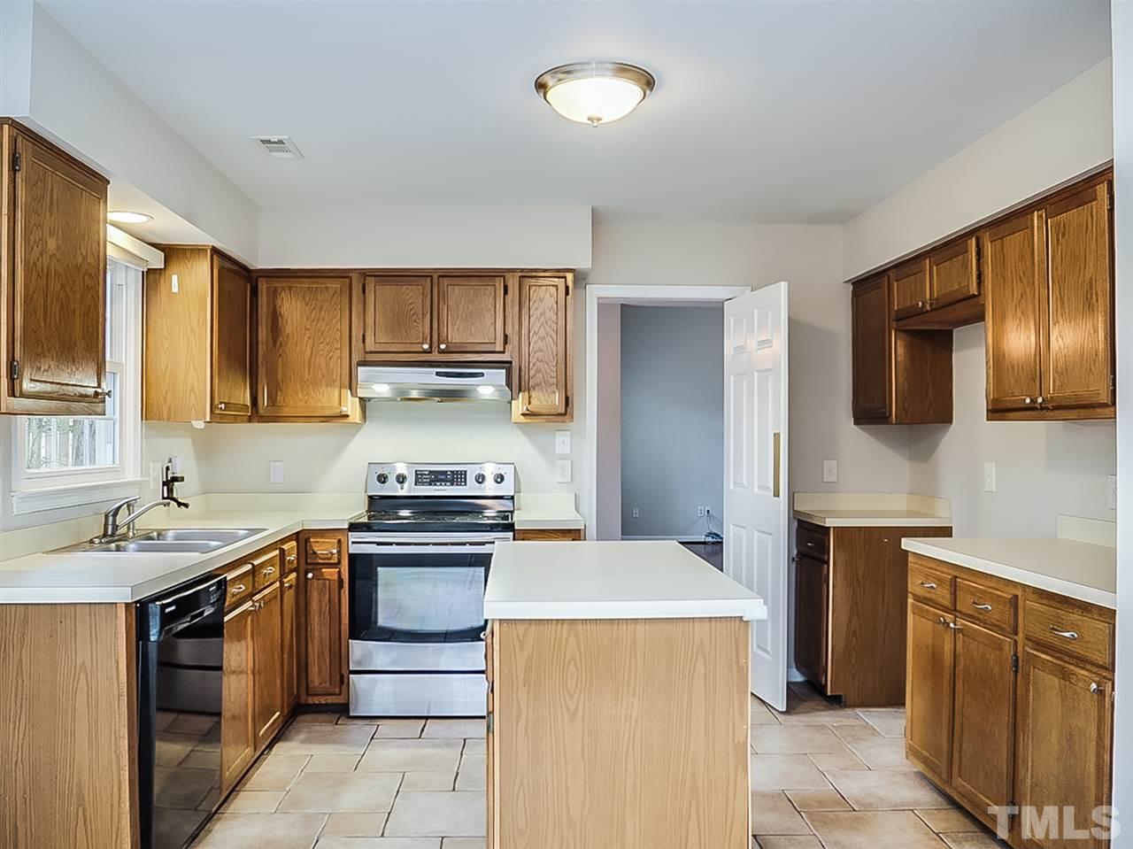 5813 Edgebury Road Raleigh, NC 27613 - Photo 2 of 21 a kitchen with a stove sink and refrigerator