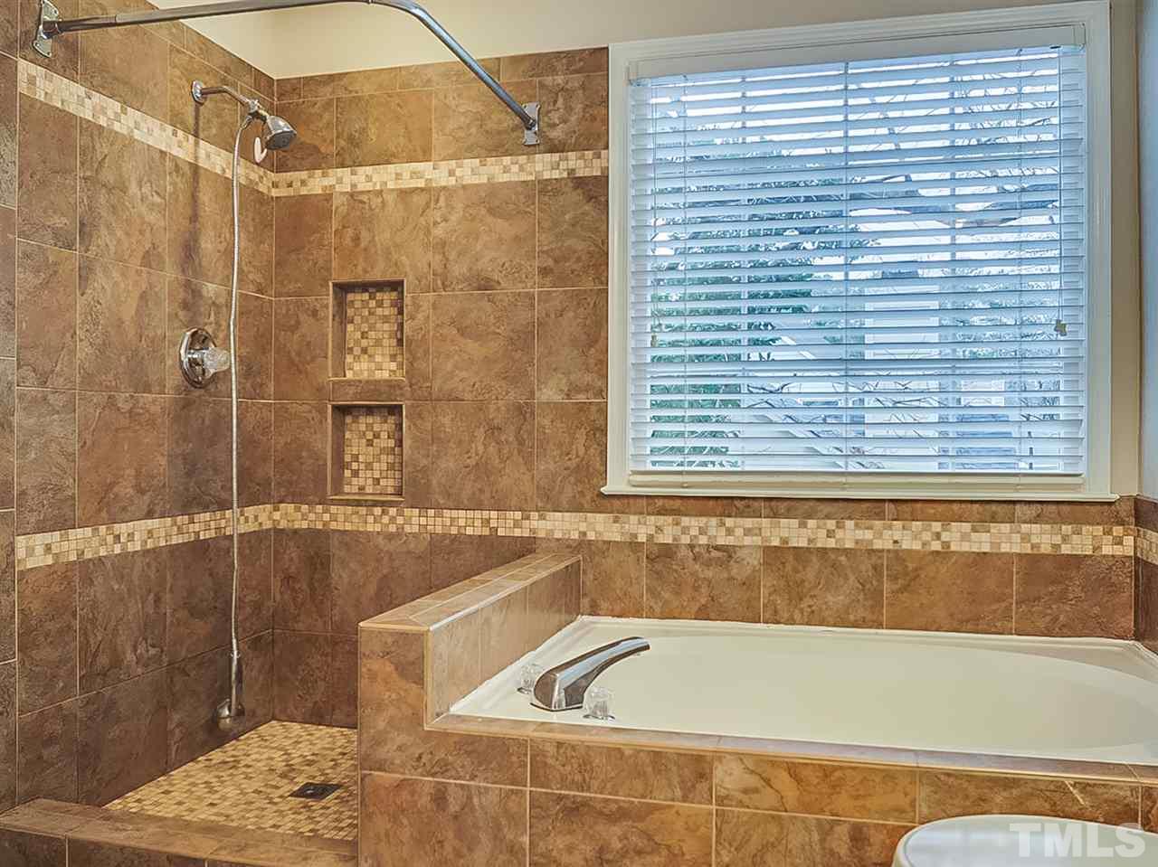 5813 Edgebury Road Raleigh, NC 27613 - Photo 13 of 21 a bathroom with a bathtub and shower