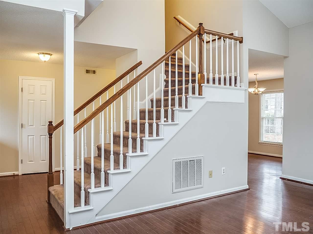 5813 Edgebury Road Raleigh, NC 27613 - Photo 8 of 21 a view of staircase with railing and white walls