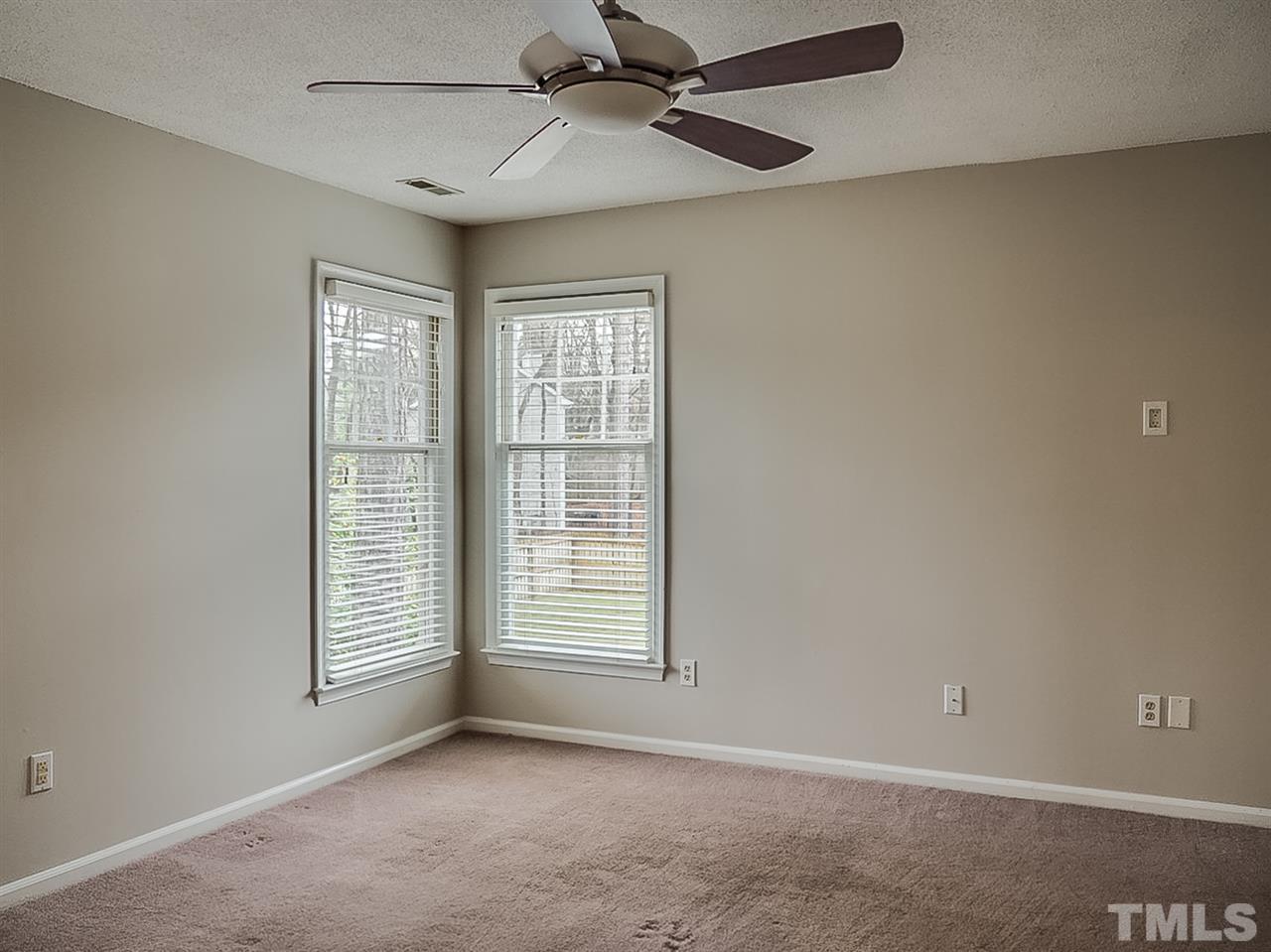 5813 Edgebury Road Raleigh, NC 27613 - Photo 10 of 21 an empty room with windows and fan