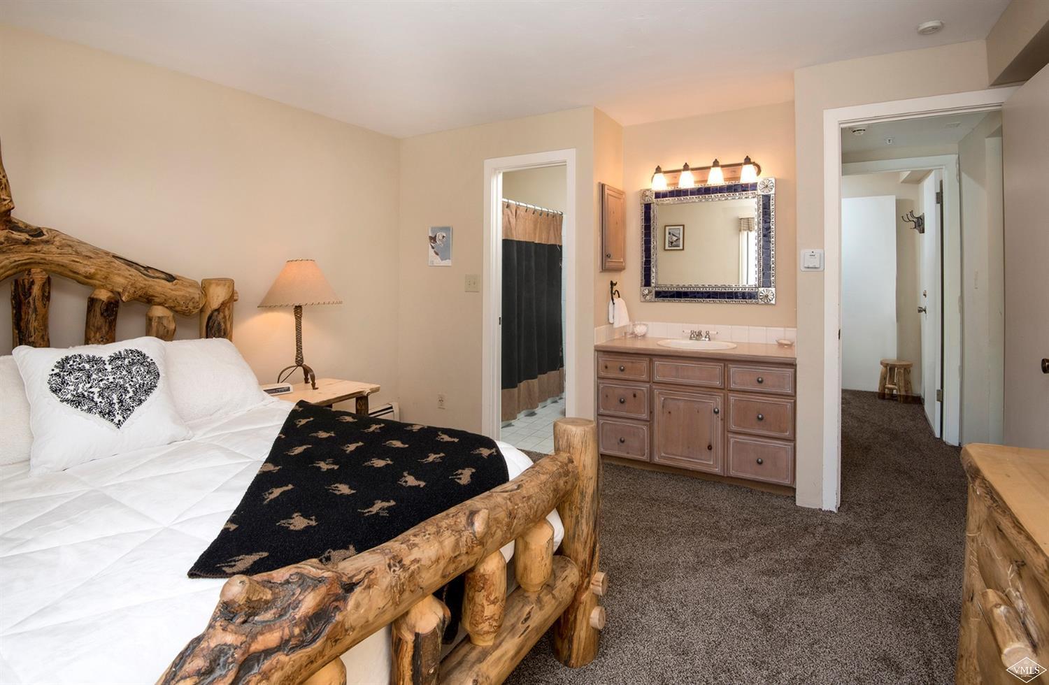 993 Lions Ridge Loop, Unit 325 Vail, CO 81657 - Photo 12 of 19 a bedroom with a bed and a view of bathroom