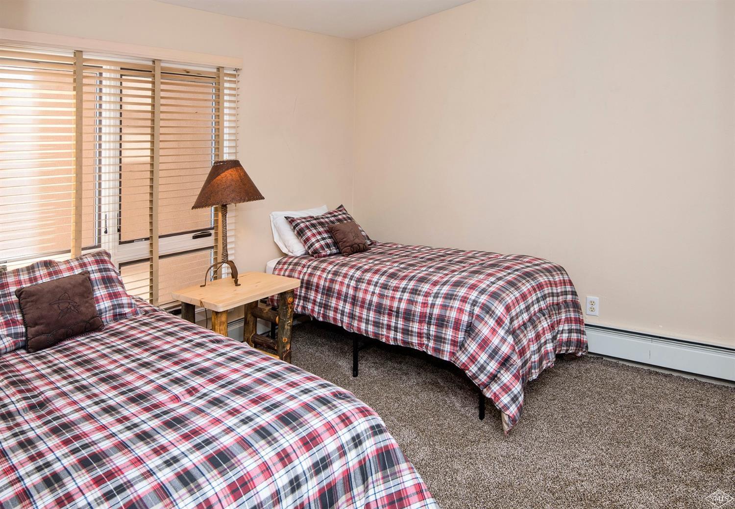 993 Lions Ridge Loop, Unit 325 Vail, CO 81657 - Photo 15 of 19 a bedroom with two beds and a window