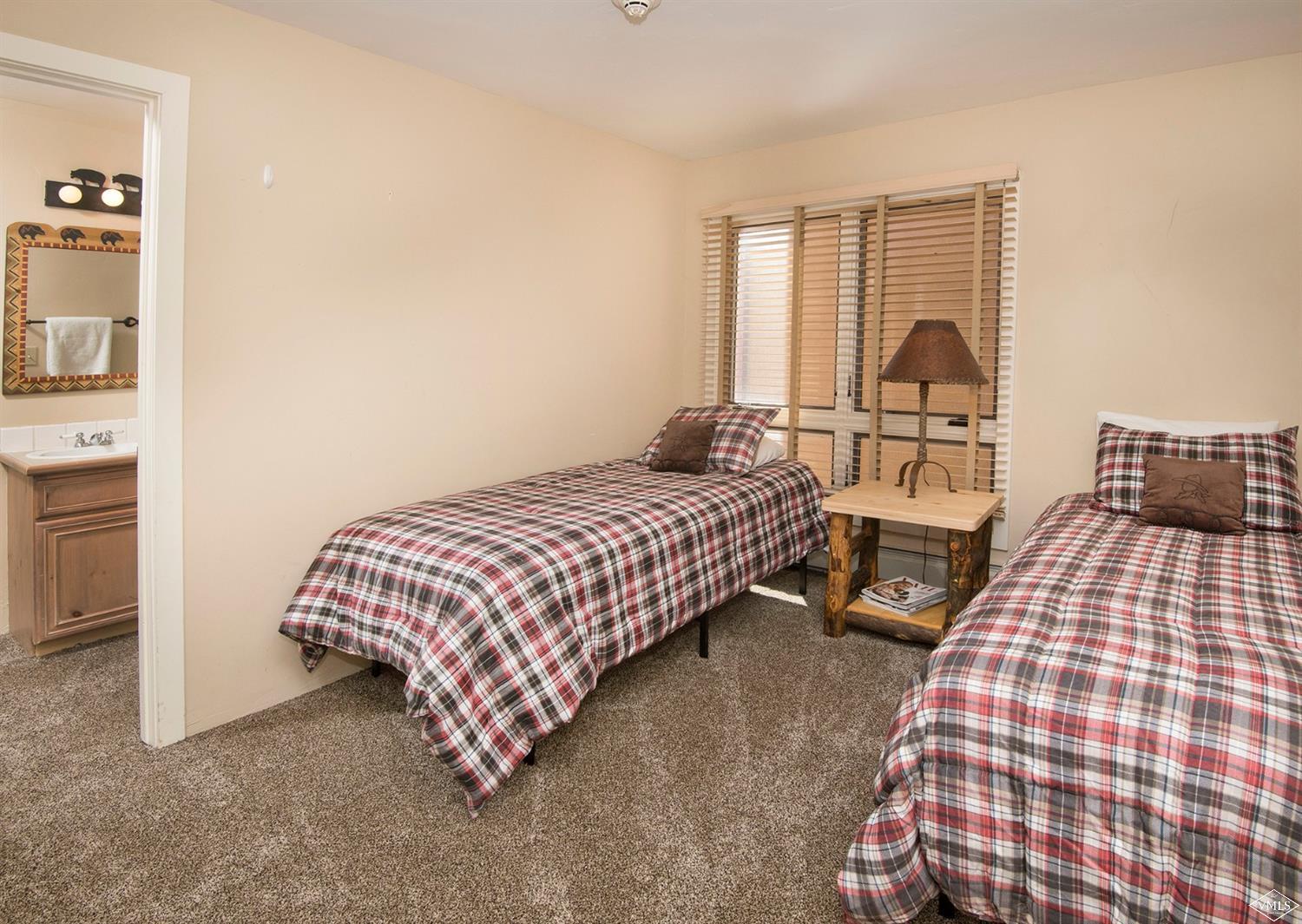 993 Lions Ridge Loop, Unit 325 Vail, CO 81657 - Photo 16 of 19 a bedroom with a bed and walk in closet