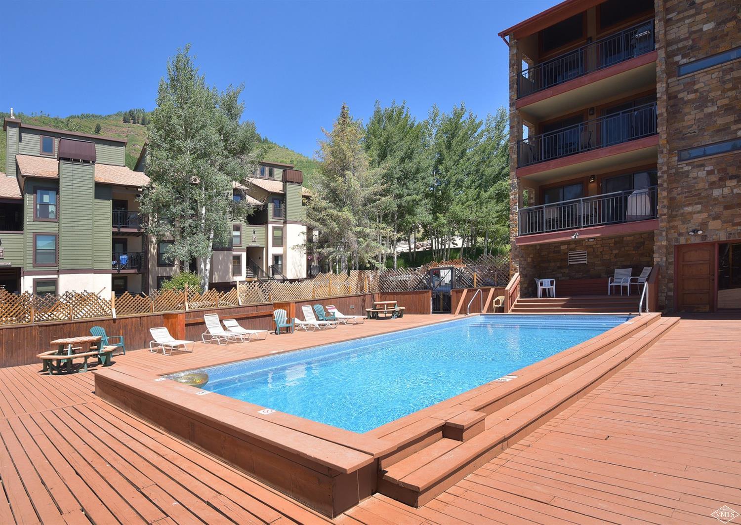 993 Lions Ridge Loop, Unit 325 Vail, CO 81657 - Photo 18 of 19 a view of a swimming pool with a lounge chairs
