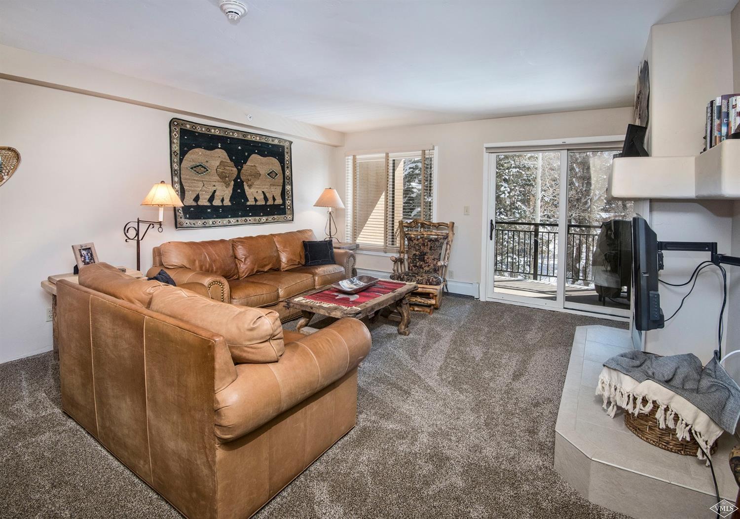 993 Lions Ridge Loop, Unit 325 Vail, CO 81657 - Photo 2 of 19 a living room with furniture and a large window