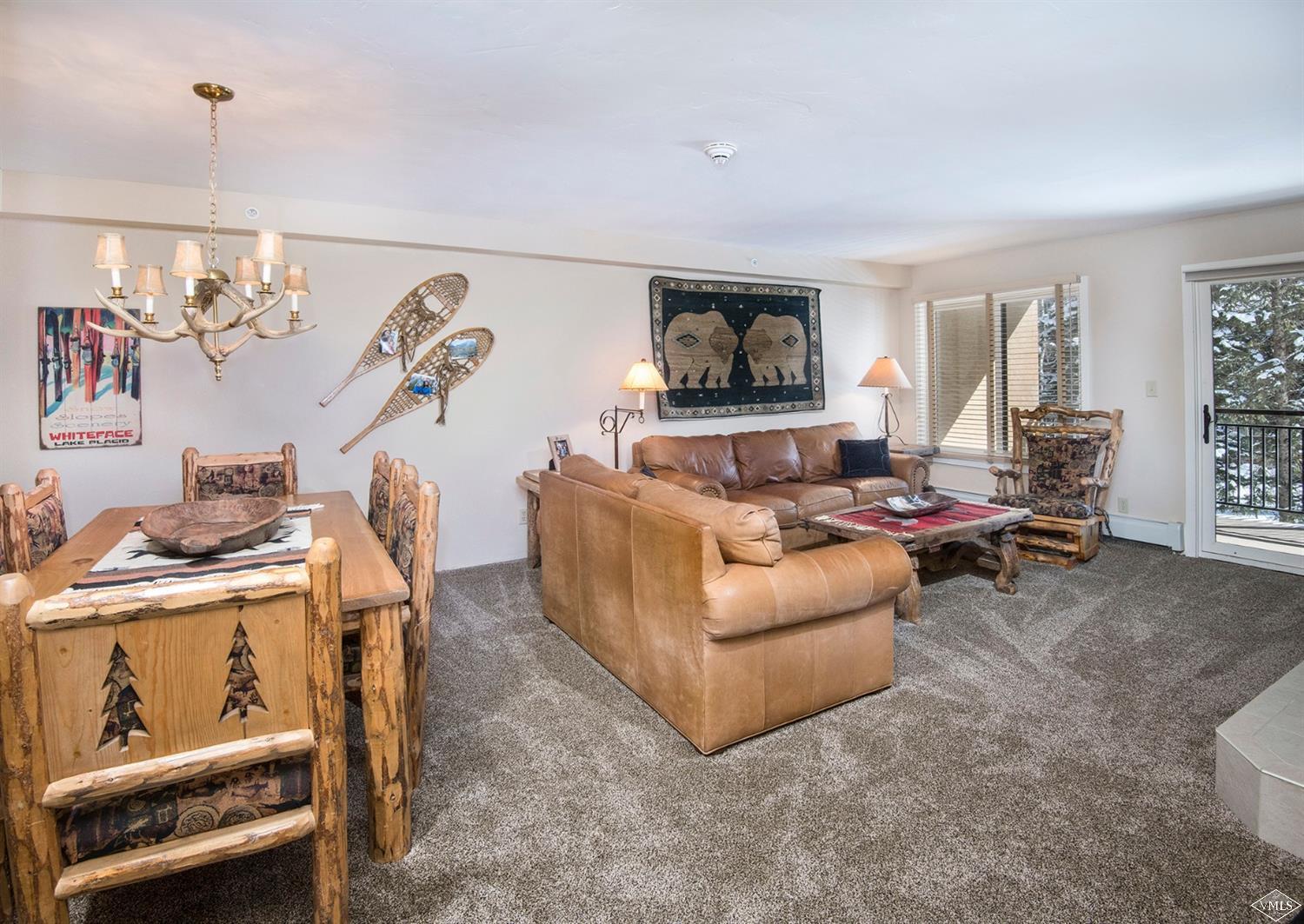 993 Lions Ridge Loop, Unit 325 Vail, CO 81657 - Photo 3 of 19 a living room with furniture and a flat screen tv