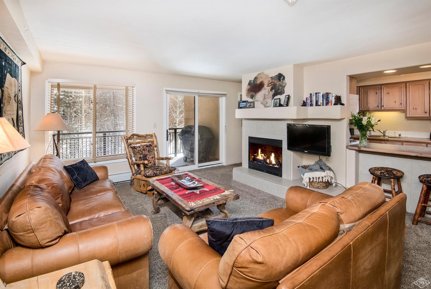 993 Lions Ridge Loop, Unit 325 Vail, CO 81657 - Photo 4 of 19 a living room with furniture and a fireplace