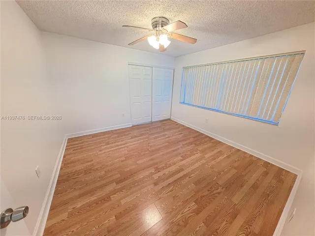 a view of room with a ceiling fan and window