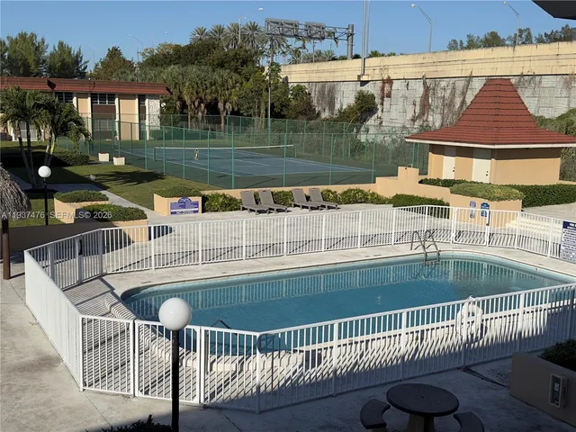 swimming pool view with a seating space