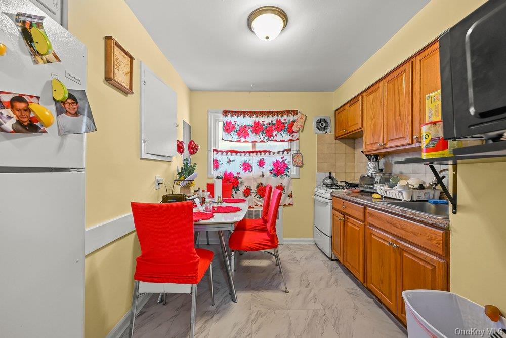 40 Firwood Road, Unit MAIN ST Port Washington, NY 11050 - Photo 11 of 18 a view of a dining room with furniture