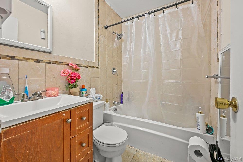 40 Firwood Road, Unit MAIN ST Port Washington, NY 11050 - Photo 12 of 18 a bathroom with a sink a toilet and shower curtain