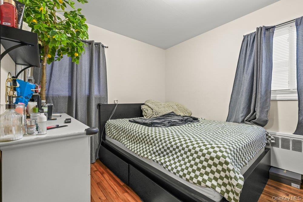 40 Firwood Road, Unit MAIN ST Port Washington, NY 11050 - Photo 13 of 18 a bedroom with a bed and a potted plant