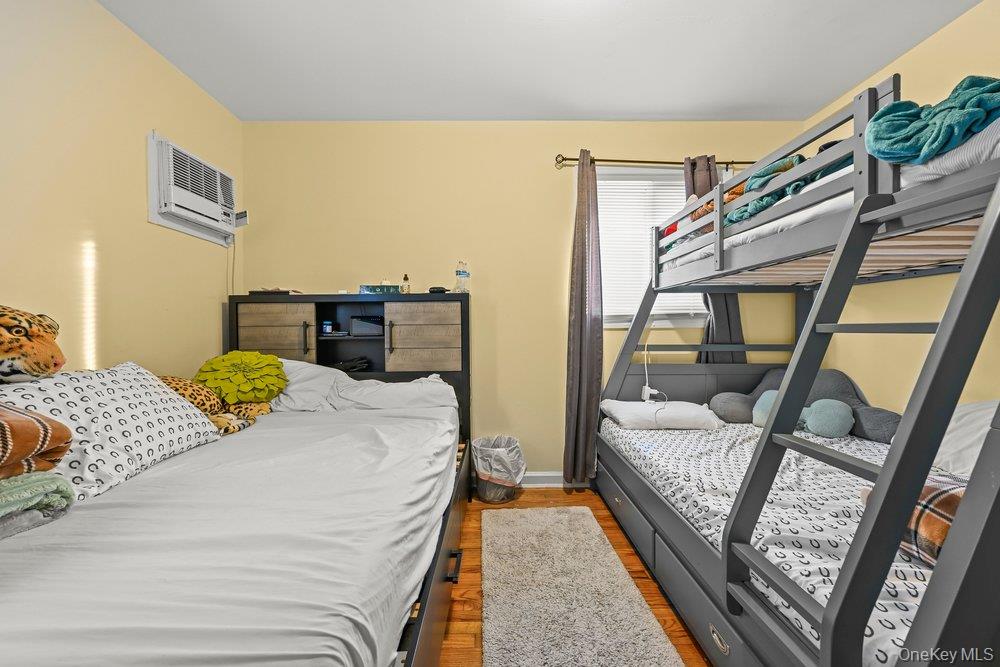40 Firwood Road, Unit MAIN ST Port Washington, NY 11050 - Photo 14 of 18 a bedroom with a bed couch and a window