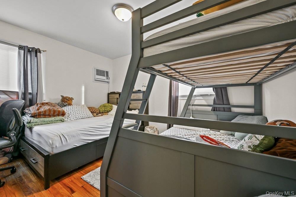 40 Firwood Road, Unit MAIN ST Port Washington, NY 11050 - Photo 15 of 18 a bedroom with a bed and wooden floor
