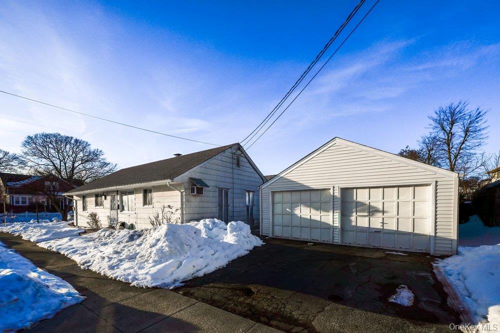 40 Firwood Road, Unit MAIN ST Port Washington, NY 11050 - Photo 17 of 18 a front view of a house with garden