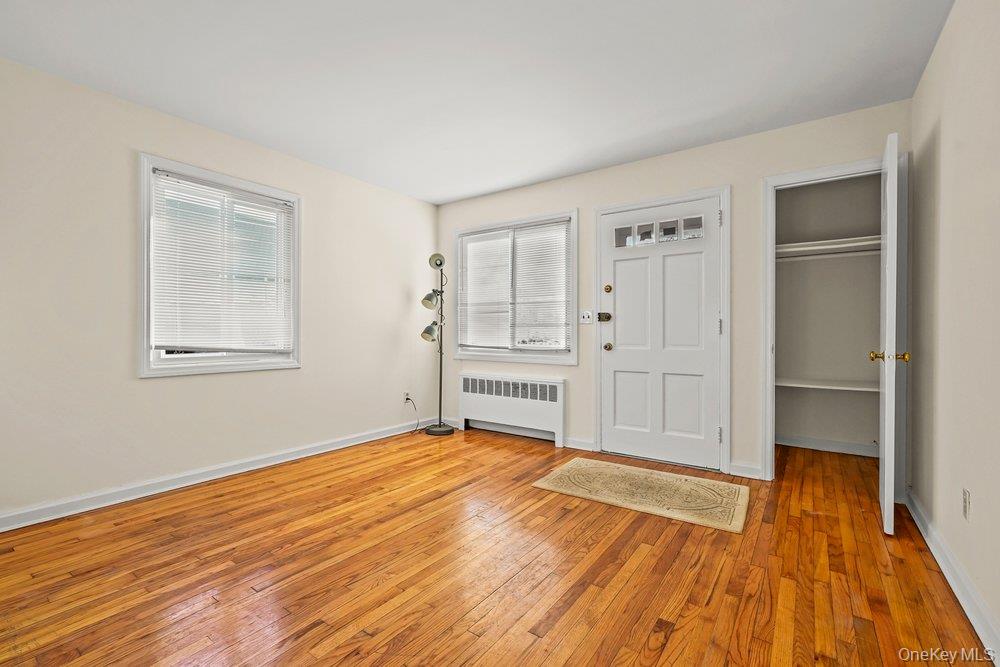 40 Firwood Road, Unit MAIN ST Port Washington, NY 11050 - Photo 3 of 18 a view of empty room with wooden floor and fan