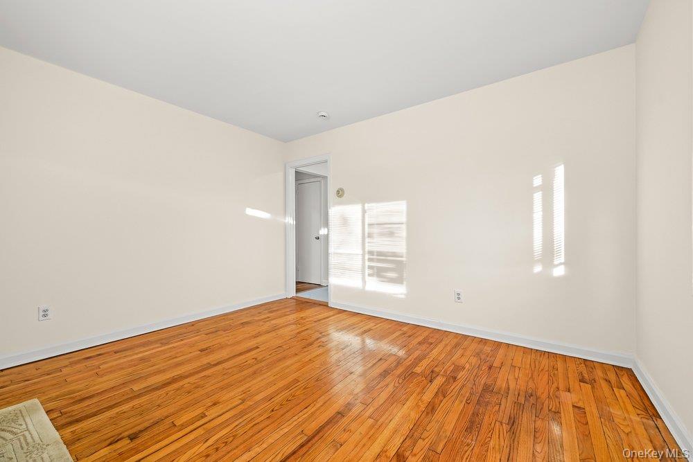 40 Firwood Road, Unit MAIN ST Port Washington, NY 11050 - Photo 4 of 18 a view of empty room with wooden floor and fan