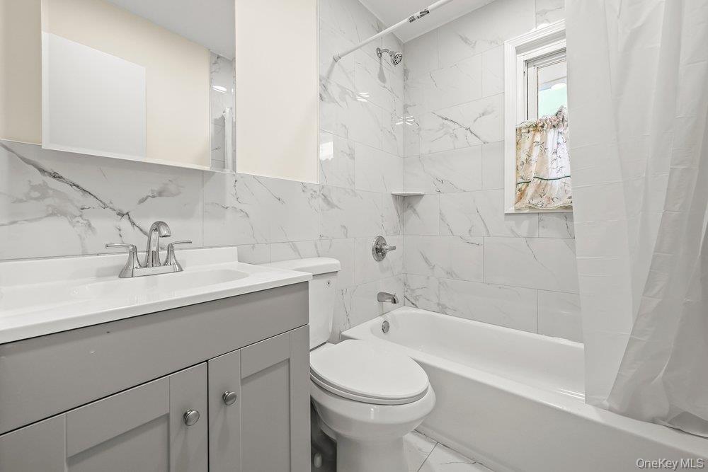 40 Firwood Road, Unit MAIN ST Port Washington, NY 11050 - Photo 6 of 18 a bathroom with a sink a toilet and shower