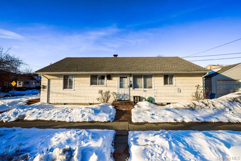 40 Firwood Road, Unit MAIN ST Port Washington, NY 11050 - Photo 9 of 18 a front view of a house with a yard