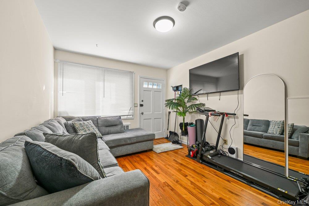 40 Firwood Road, Unit MAIN ST Port Washington, NY 11050 - Photo 10 of 18 a living room with furniture and a flat screen tv