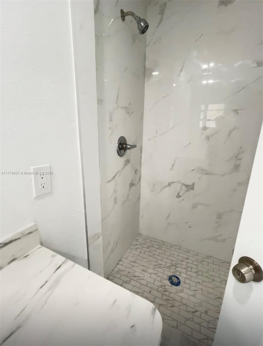 Brownsville Miami, FL 33142 - Photo 15 of 19 a bathroom with a sink and shower