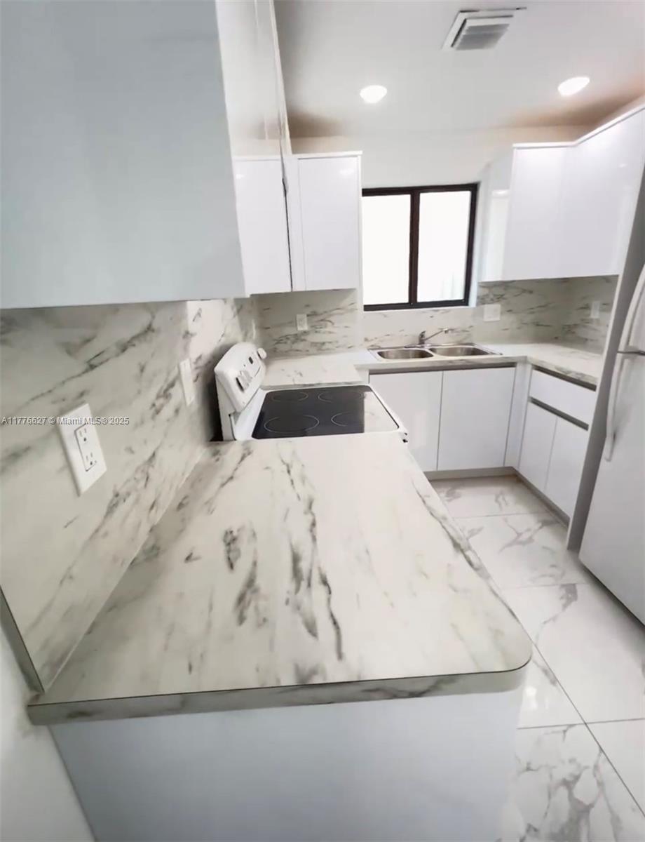 Brownsville Miami, FL 33142 - Photo 7 of 19 a kitchen with a white cabinets sink and dishwasher