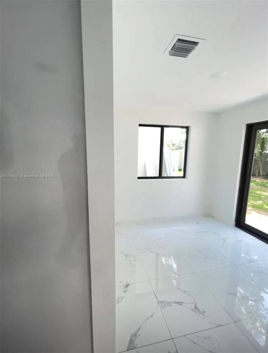 Brownsville Miami, FL 33142 - Photo 8 of 19 an empty room with windows and mirror