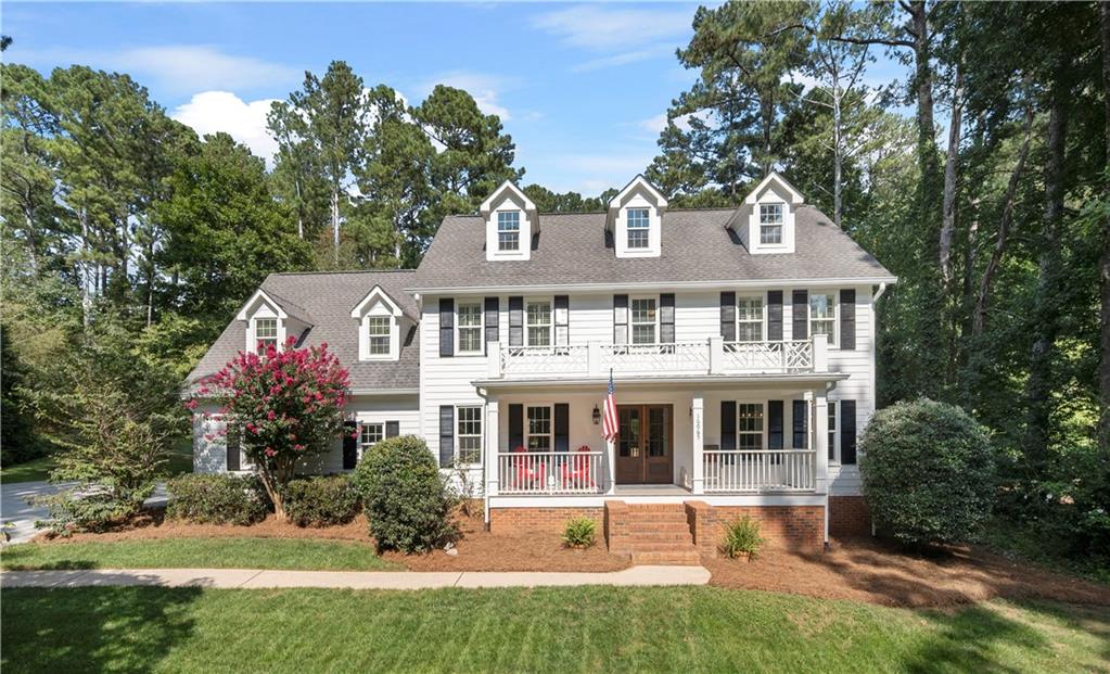 16065 Henderson Road Milton, GA 30004 - Photo 1 of 1 a front view of a house with a yard