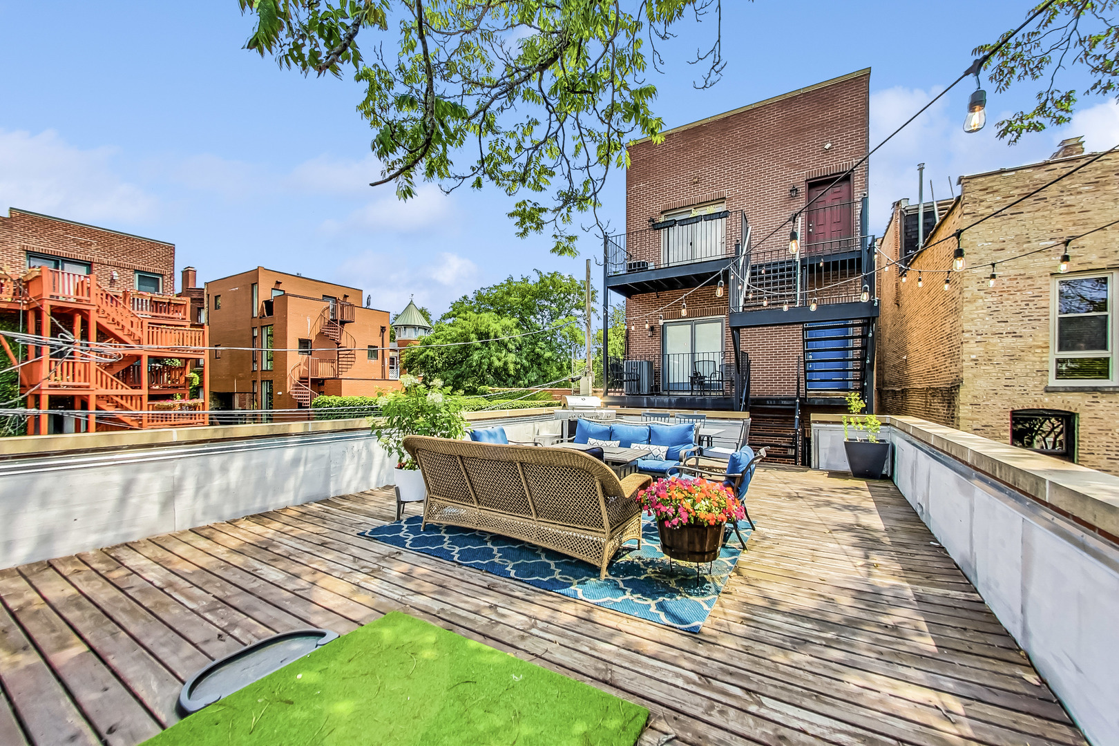 218 South Laflin Street, Unit 101 Chicago, IL 60607 - Photo 16 of 22 a view of a chairs and table on the wooden deck