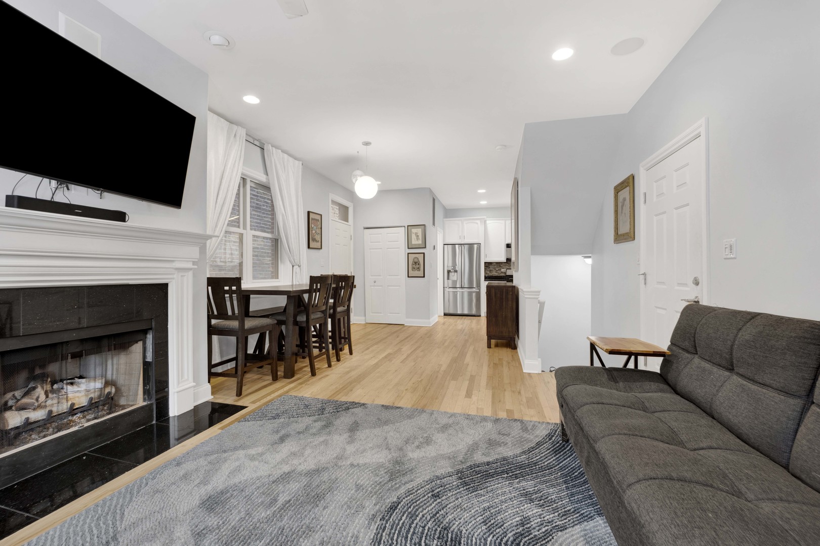 218 South Laflin Street, Unit 101 Chicago, IL 60607 - Photo 4 of 22 a living room with furniture and a flat screen tv